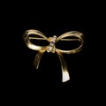 Gold jewelry in the form of a bow with white crystals. Royalty Free Stock Photo