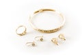 gold jewelry isolated white background. earrings, bracelet and ring
