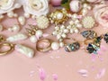 Gold jewelry with pearls blue crystal gems, rings, necklace close up shot ,on pink background women accessories Royalty Free Stock Photo