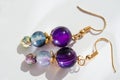 gold jewerly earrings with agat and fluorite semiprecious at white background