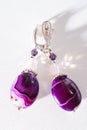 Gold jewerly earrings with agat and fluorite semiprecious at white background