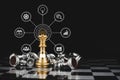 Gold king surrounded with silver chess pieces on chess board game competition with virtual digital icon