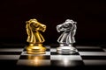 Gold knight chess facing silver knight chess on chess board , bu Royalty Free Stock Photo