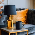 Gold Lamp Black Mug and Mustard Pillow on a Grey Sofa Royalty Free Stock Photo