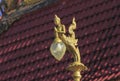 Gold lamps and lighting pole background with a blue sky,at Wat Ban Ngao (Temple), Ranong, Thailand
