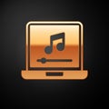 Gold Laptop with music note symbol on screen icon isolated on black background. Vector