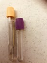 Gold and lavender top blood sample vacuum tubes.