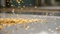 Gold leaf sheets scatter softly in air creating delicate shimmer and elegant texture on smooth surface below in warm light Royalty Free Stock Photo