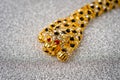 Gold leopard bracelet with shiny pebbles, lepard eyes made of bright red stones Royalty Free Stock Photo