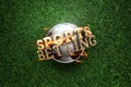 Gold Lettering Sports Betting on the background of a soccer ball and green lawn. Bets, sports betting, watch sports and bet. flat Royalty Free Stock Photo