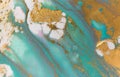 Gold and light blue mixed inks spilled on white paper background. Turquoise texture. Royalty Free Stock Photo