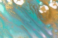 Gold and light blue mixed inks spilled on white paper background. Turquoise texture. Royalty Free Stock Photo