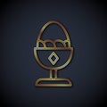 Gold line Chicken egg on a stand icon isolated on black background. Vector