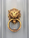 Gold lion head door knocker with the ring on its mouth on the entrance of a house, Malta. Italian traditional doorknob. Royalty Free Stock Photo