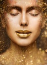 Gold Lip Gloss Make up Closeup. Beauty Model Face Portrait with Closed Eyes and Golden Sparkles on Skin. Luxury Woman Skin Care