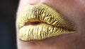 Gold lips, golden lipgloss on sexy lips, metallic mouth. Beauty woman mouth. Sexy girl golden lips, gold mouth. Glowing