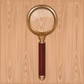 Gold magnifier with red handle. Reading glass