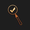 Gold Magnifying glass and check mark icon isolated on black background. Magnifying glass and approved, confirm, done Royalty Free Stock Photo