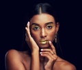 Gold makeup, serious and portrait of a woman isolated on a black background in a studio. Beauty, young and glamorous Royalty Free Stock Photo