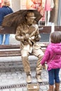 Gold man show a little girl