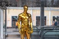 Gold mannequin standing in a shop window. Sale of things and sales concept