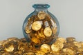 Gold market concept coins stored in bottles, representing wealth Royalty Free Stock Photo