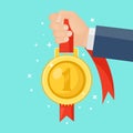 Gold medal with red ribbon for first place in hand. Trophy, winner award isolated on background. Golden badge icon. Sport, Royalty Free Stock Photo