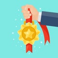 Gold medal with red ribbon, star for first place in hand. Trophy, winner award isolated on background. Golden badge icon. Sport, Royalty Free Stock Photo