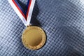 Gold medal on velvet cushion. Olympic games Royalty Free Stock Photo