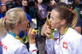 Athletes kissing Olympic gold medal