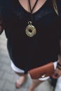 Gold medallion hanging on woman`s neck. Royalty Free Stock Photo