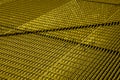 Gold metal grid, diagonal pattern. Interlaced bars create a geometric texture Royalty Free Stock Photo