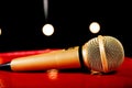 Gold microphone on dark background with many lights Royalty Free Stock Photo