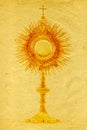 Gold monstrance on grunge paper Royalty Free Stock Photo