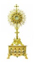 Gold monstrance on the pedestal engraving 4 saints on white back Royalty Free Stock Photo