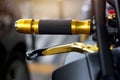 Gold motorcycle handle on street background