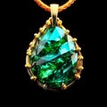 a gold necklace with an emerald colored tear on it's end