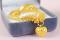 The Gold necklace and heart shape pendant with ring on blue velvet box Royalty Free Stock Photo