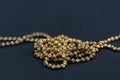 Gold necklace isolated on black background, macro closeup showing yellow golden chain links detail