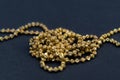 Gold necklace isolated on black background, macro closeup showing yellow golden chain links detail