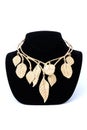 Gold necklace with leaves on a mannequin isolated on white Royalty Free Stock Photo