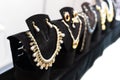 Gold necklace with stones and pearls in a jewelry store window. Selective focus Royalty Free Stock Photo