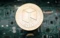 Gold neo coin, on background of computer motherboard
