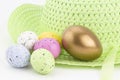 Gold nest egg stands out from pastel eggs Royalty Free Stock Photo