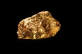 Gold nugget on black background. Royalty Free Stock Photo