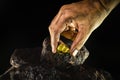 Gold nugget in a miner`s hand, hidden gold stone Royalty Free Stock Photo