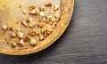 Gold nuggets on brass plate top view. Imitation of gold nuggets Royalty Free Stock Photo