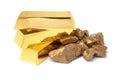 Gold nuggets and ingots on white Royalty Free Stock Photo