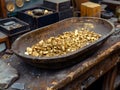 Gold nuggets in a pan at a mining site Royalty Free Stock Photo