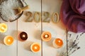Gold numbers 2020 on a background of white boards next to sea salt for spa treatments, scented candles and a sprig of lavender lie